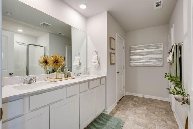 310 Weston Dr, Lewisburg, TN 37091 - bathroom featuring a stall shower, stone finish floor, visible vents, and a sink