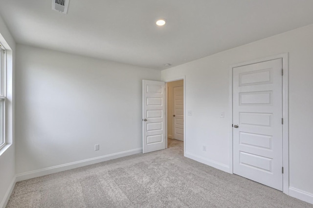 unfurnished bedroom featuring recessed lighting, visible vents, baseboards, and carpet floors