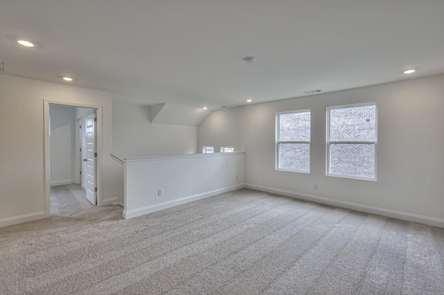 carpeted empty room with baseboards and recessed lighting