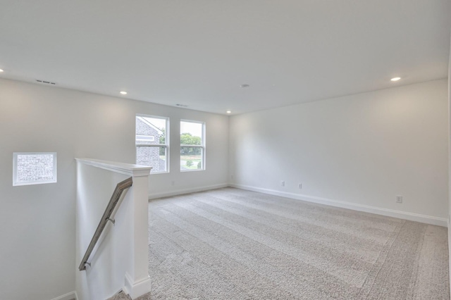unfurnished room with light carpet, baseboards, visible vents, and recessed lighting