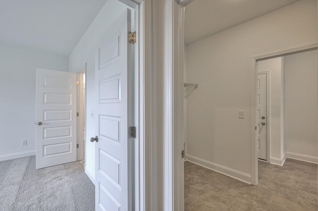 corridor featuring baseboards