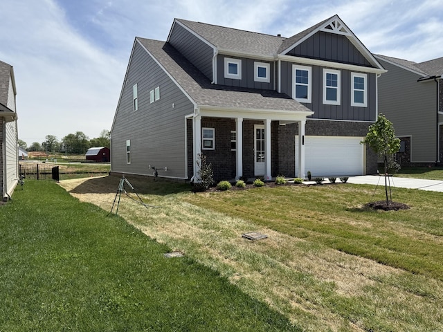 craftsman house featuring an attached garage, concrete driveway, board and batten siding, a front yard, and brick siding