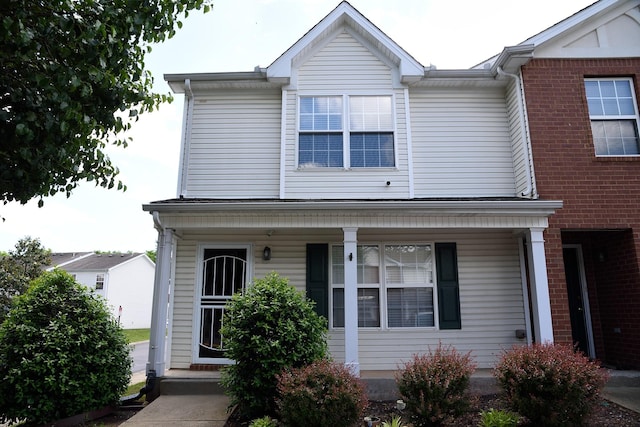 traditional-style house featuring covered porch