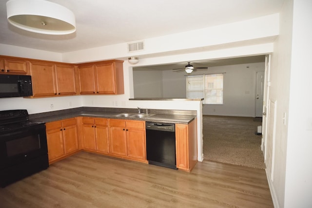 301 Arapaho Dr, Murfreesboro, TN 37128 - kitchen featuring black appliances, a sink, light wood finished floors, a peninsula, and a ceiling fan