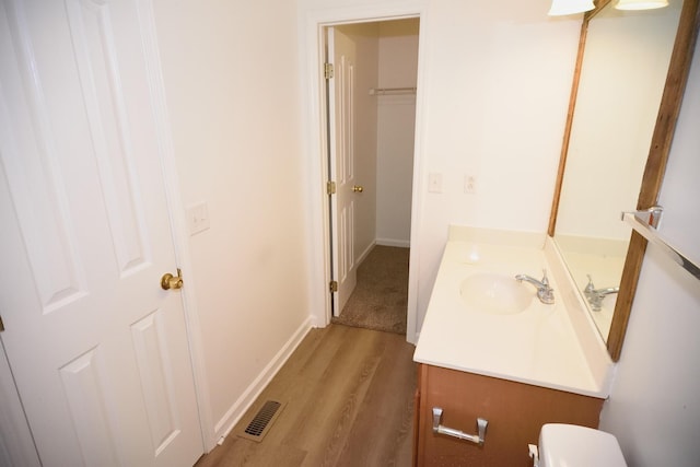 301 Arapaho Dr, Murfreesboro, TN 37128 - bathroom featuring vanity, wood finished floors, toilet, and baseboards