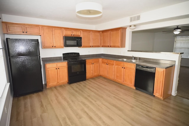 301 Arapaho Dr, Murfreesboro, TN 37128 - kitchen with black appliances, a sink, light wood-style flooring, dark countertops, and ceiling fan