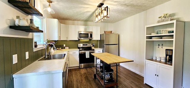 429 E Castle St, Murfreesboro, TN 37130 - kitchen with stainless steel appliances, a textured ceiling, a sink, open shelves, and light countertops