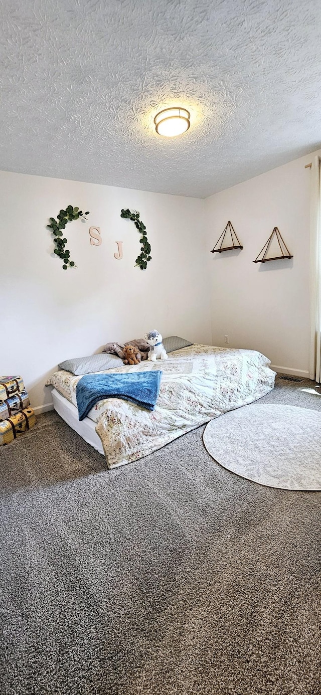 429 E Castle St, Murfreesboro, TN 37130 - carpeted bedroom featuring a textured ceiling and baseboards