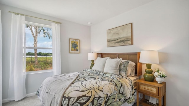 carpeted bedroom featuring baseboards