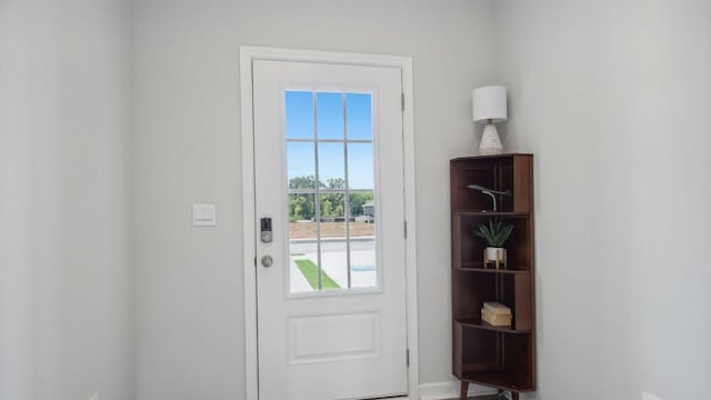 doorway to outside with baseboards