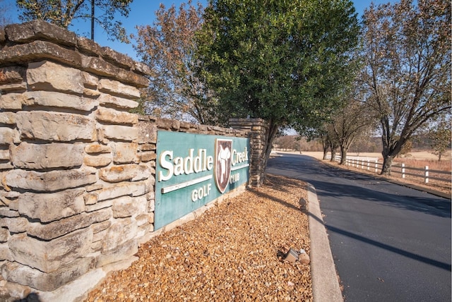 community sign featuring fence