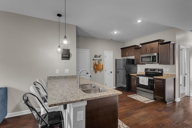 1803 Villa Cir, Lebanon, TN 37090 - kitchen featuring a sink, a kitchen bar, dark brown cabinetry, a peninsula, and appliances with stainless steel finishes
