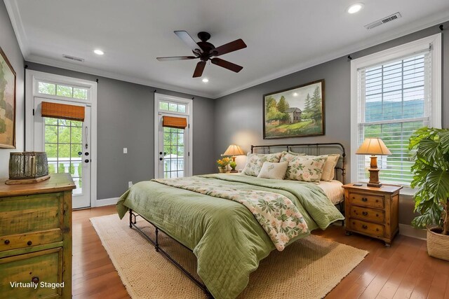 bedroom featuring light wood finished floors, ornamental molding, visible vents, and access to exterior