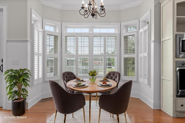 dining room featuring a notable chandelier, light wood-style floors, and a healthy amount of sunlight