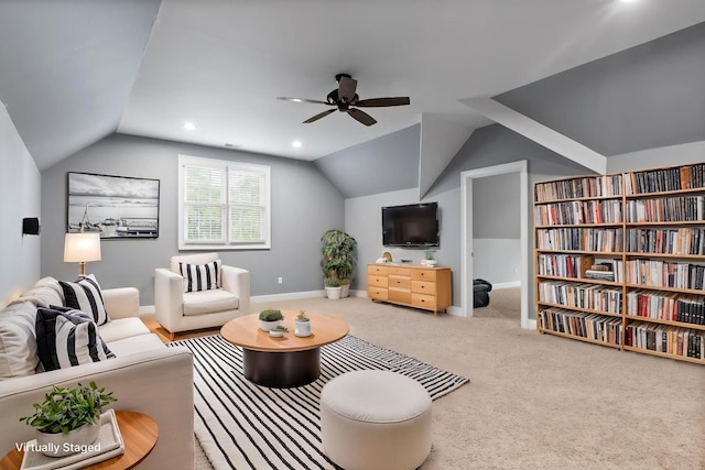 carpeted living room with a ceiling fan, baseboards, and vaulted ceiling