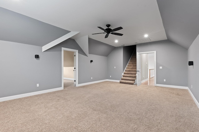 bonus room featuring a ceiling fan, light carpet, baseboards, and vaulted ceiling