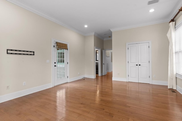 interior space with crown molding, light wood-style flooring, baseboards, and plenty of natural light