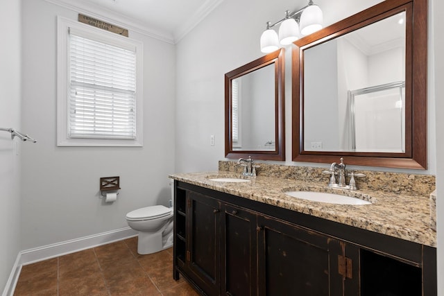 bathroom featuring a sink, ornamental molding, baseboards, and toilet