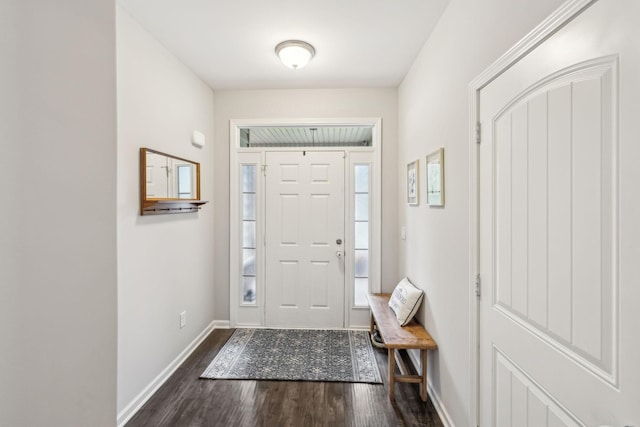 foyer entrance with baseboards and dark wood-type flooring