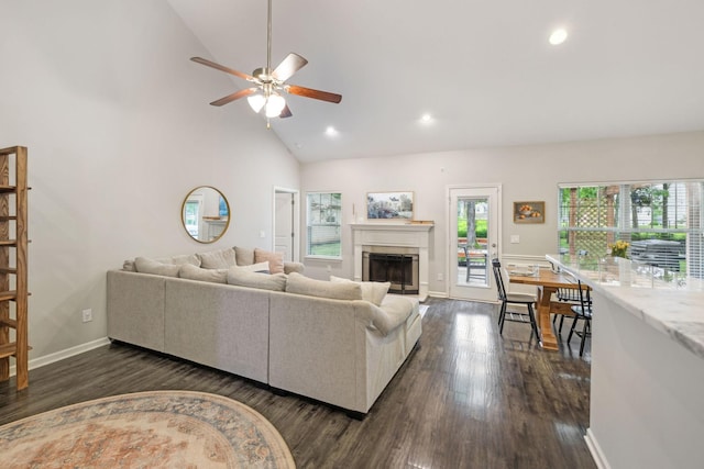 living area featuring high vaulted ceiling, recessed lighting, a fireplace, ceiling fan, and dark wood finished floors