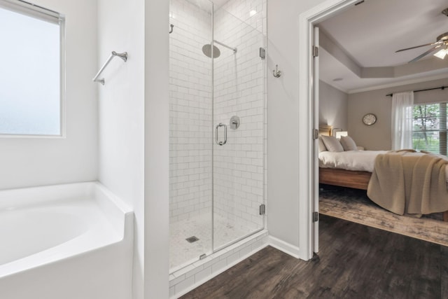 ensuite bathroom featuring a ceiling fan, ensuite bathroom, a bath, a shower stall, and wood finished floors