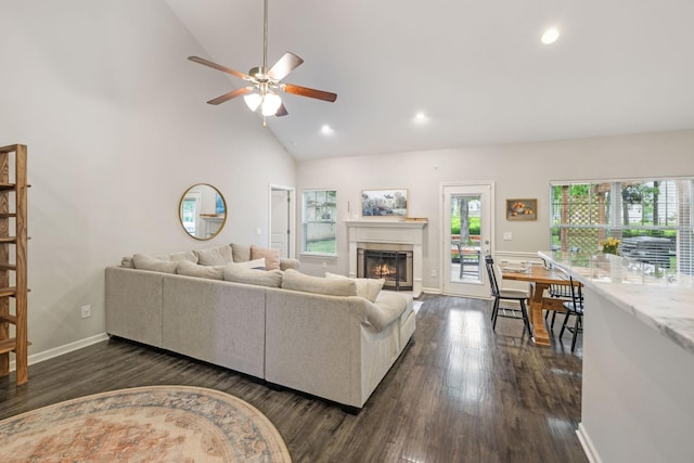 living room featuring a lit fireplace, ceiling fan, dark wood-style flooring, and recessed lighting