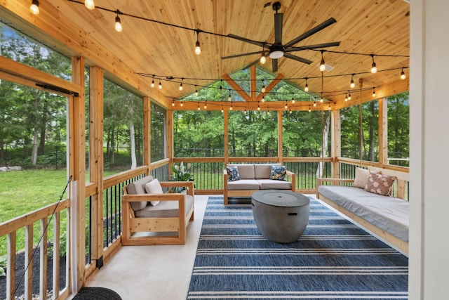 sunroom with a ceiling fan, a wealth of natural light, outdoor lounge area, and track lighting