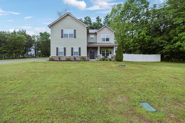 view of front of home featuring a front lawn, a porch, and fence