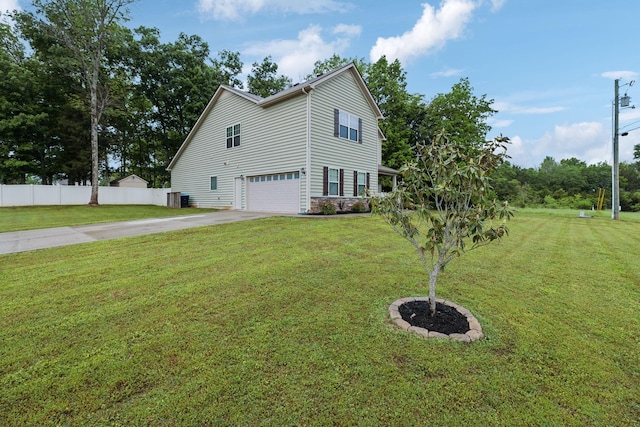 view of property exterior with concrete driveway, a yard, an attached garage, and fence