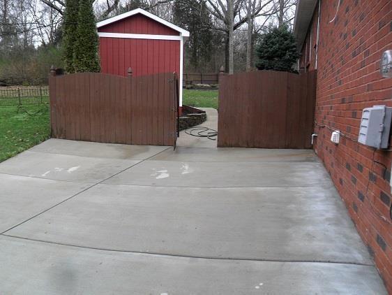 view of patio with a shed, fence, and an outbuilding