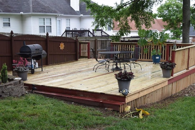 deck featuring fence, area for grilling, and outdoor dining space