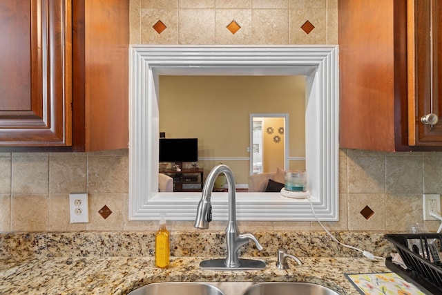 4006 Greentree Ct W, Smyrna, TN 37167 - kitchen view of a sink, light stone counters, and backsplash