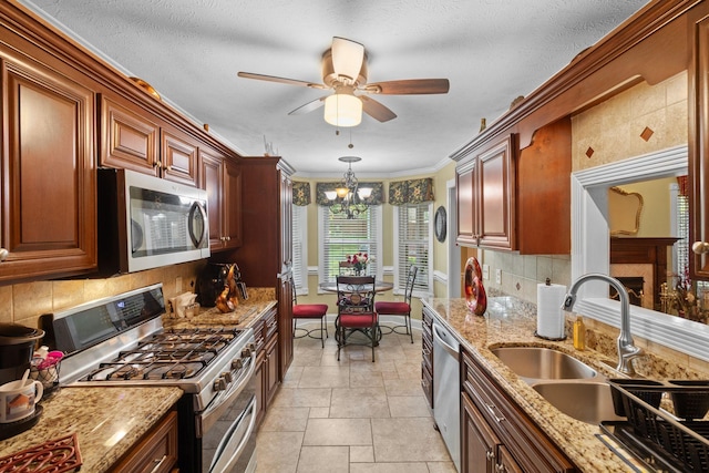 4006 Greentree Ct W, Smyrna, TN 37167 - kitchen with appliances with stainless steel finishes, a sink, tasteful backsplash, a ceiling fan, and a chandelier