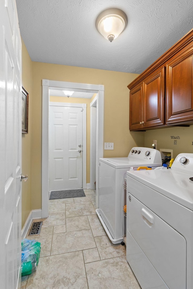 4006 Greentree Ct W, Smyrna, TN 37167 - laundry area featuring cabinet space, washer and clothes dryer, baseboards, and a textured ceiling