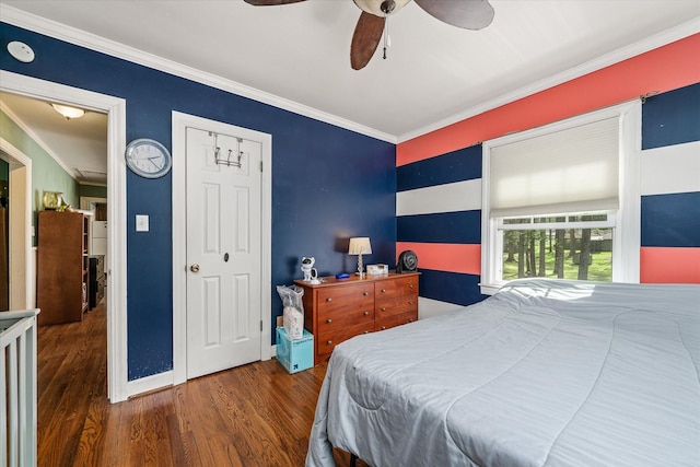 bedroom with crown molding, wood finished floors, baseboards, and ceiling fan