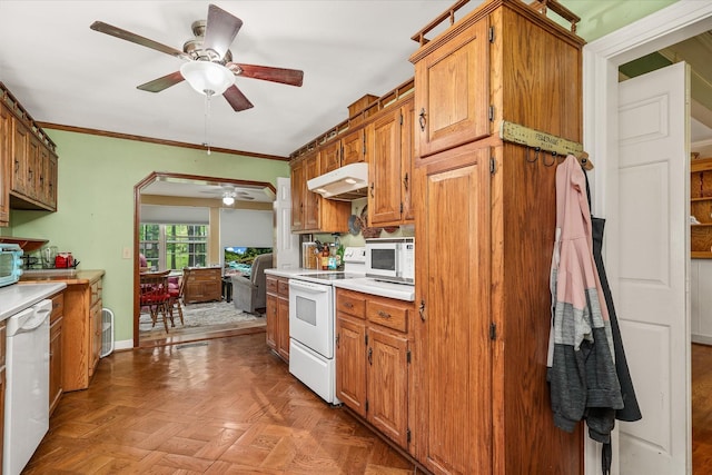 kitchen with baseboards, ceiling fan, white appliances, under cabinet range hood, and light countertops
