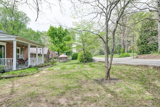view of yard featuring cooling unit and a porch