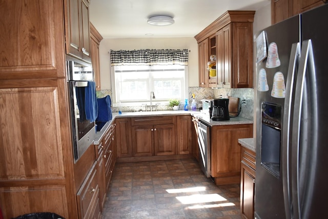 1011 Cornersville Rd, Lewisburg, TN 37091 - kitchen featuring a sink, brown cabinets, light countertops, tasteful backsplash, and appliances with stainless steel finishes