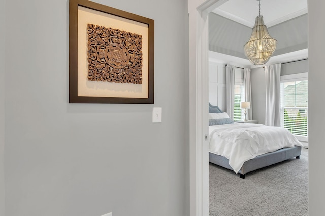 carpeted bedroom with a chandelier