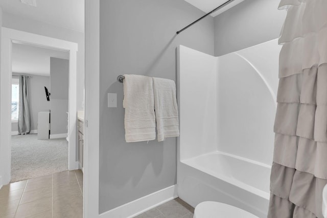 bathroom featuring baseboards,  shower combination, tile patterned floors, and vanity