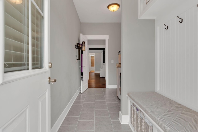 mudroom featuring washer / dryer and light tile patterned floors