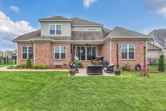 back of house with a ceiling fan, fence, a lawn, a shingled roof, and brick siding