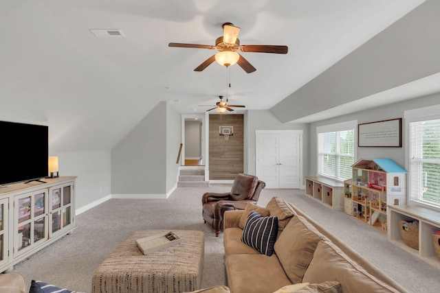 living area featuring visible vents, vaulted ceiling, carpet floors, a ceiling fan, and baseboards