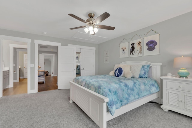 bedroom with light colored carpet, attic access, baseboards, and ceiling fan