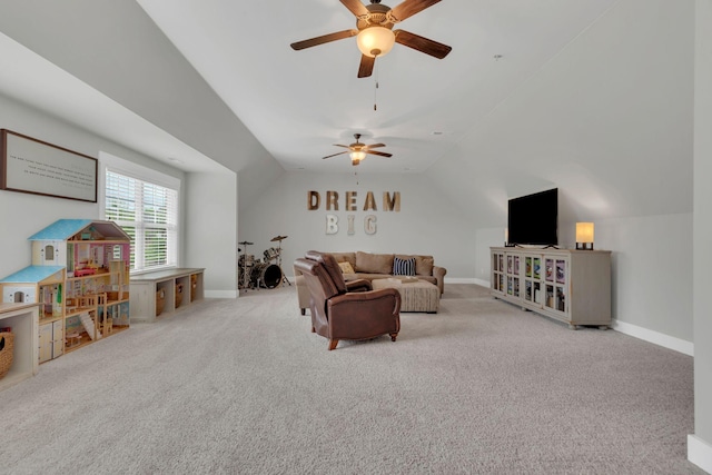 carpeted living room with vaulted ceiling, ceiling fan, and baseboards