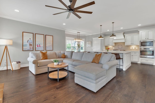 living room with dark wood-type flooring, recessed lighting, crown molding, a ceiling fan, and baseboards