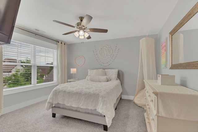 bedroom featuring light carpet, baseboards, a ceiling fan, and visible vents