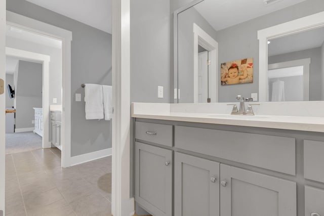 bathroom with baseboards, tile patterned flooring, vanity, and visible vents