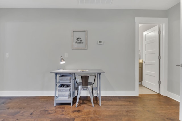 interior space with wood finished floors, visible vents, and baseboards