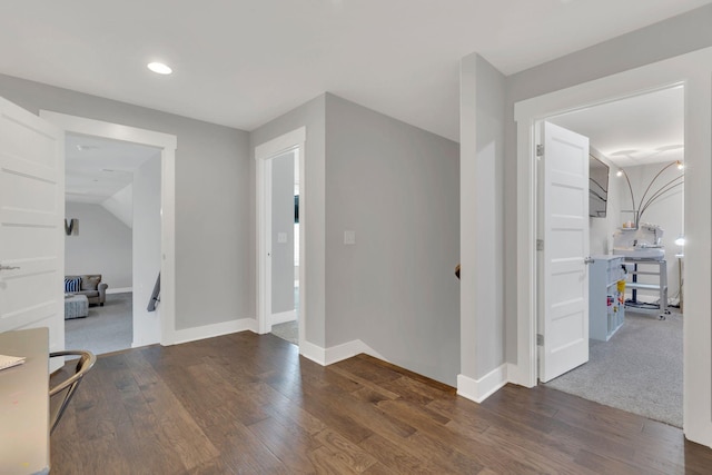 entryway with wood finished floors, baseboards, and recessed lighting